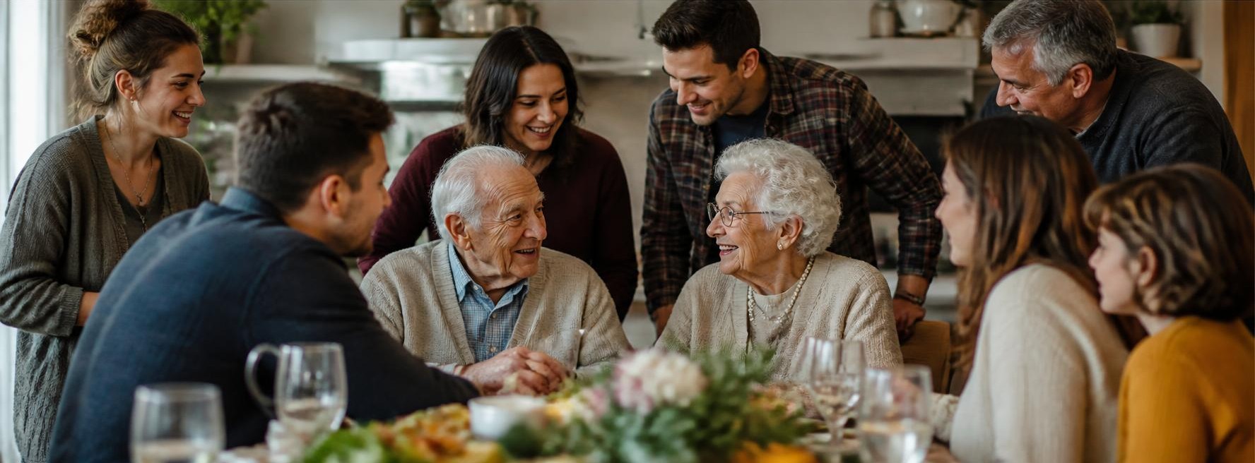 A multi-generational family gathered around a table, sharing a meal and conversation together